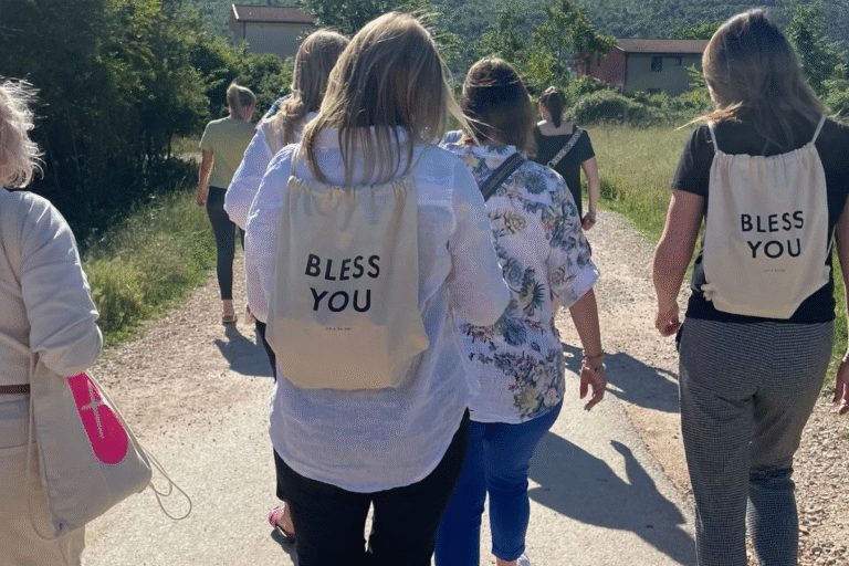 Pielgrzymi na trasie z plecakami typu worek z przesłaniem Bless You